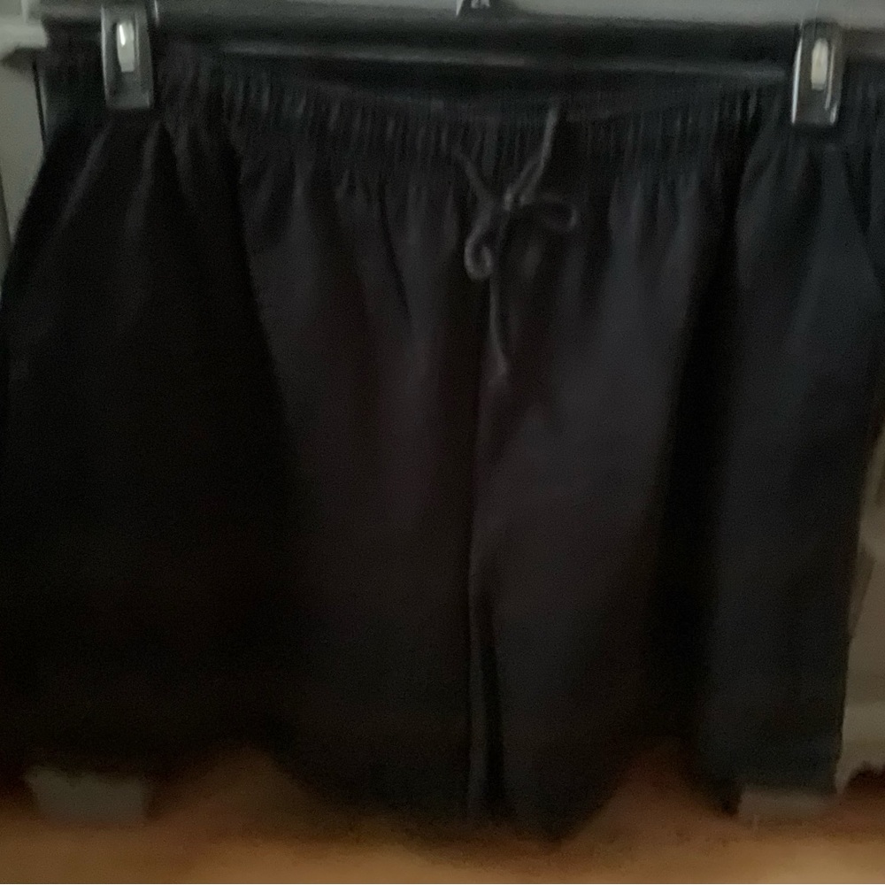 These are a pair of black shorts and navy blue shorts